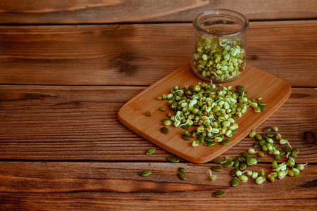 Sprouts of healthy microgreens in jar on wooden backgroundの写真素材