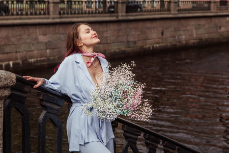 Girl in blue jacket with pink flowersの写真素材