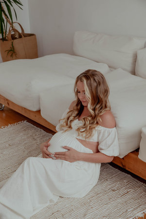 Pregnant beautiful girl in white dress.の写真素材