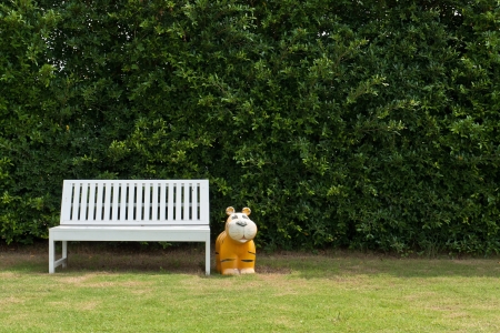 White chair for relax in a garden with tiger doll の写真素材