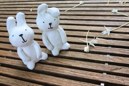 handmade statue of white rabbit on wood tableの写真素材