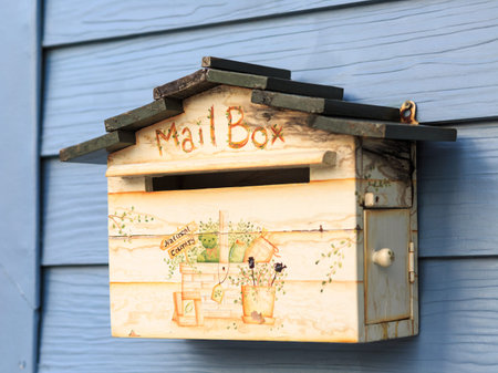 vintage mailbox hanging on blue wooden wallの写真素材