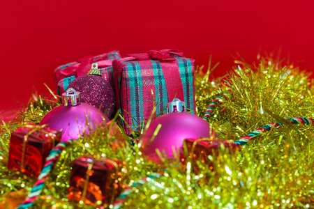 red christmas ornament with gift, box on gold twinkle fur backgroundの写真素材