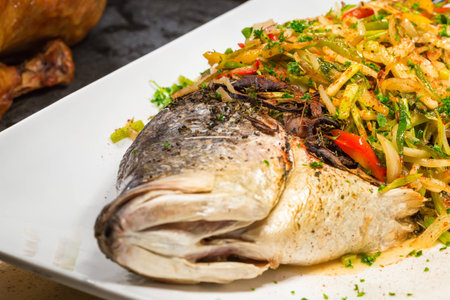 steamed fish, Thai style steamed fish in spicy sauce in white dishの写真素材