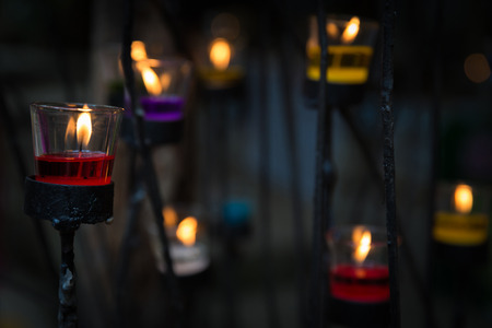 Colorful candles in glass on candlestickの写真素材