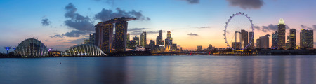 SINGAPORE - FEB 25, 2016: Cityscape panorama of Singapore city skyline with Marina Bay Sands hotel, ferris wheel and Gardens By The Bay at dusk in Marina Bayのeditorial素材