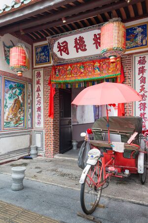 MALAYSIA - OCT 23, 2015: Rickshaw tricycles parked near the entrance to Hock Teik Cheng Sin Temple on Armenian Street in George Town, Penang, Malaysiaのeditorial素材