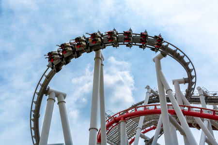 Roller coaster with people and sky background in theme parkの写真素材