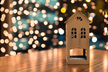 Small house model or toy house decoration on wooden table with bokeh backgroundの写真素材
