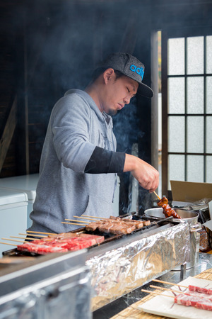 Oshino Japan - November 22 2017: Japanese barbecue grill on skewers with trader, street food in Japanのeditorial素材