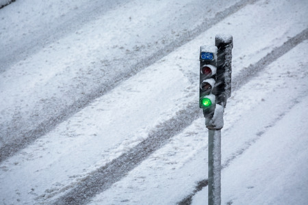 Traffic light with snow storm in winter seasonの写真素材