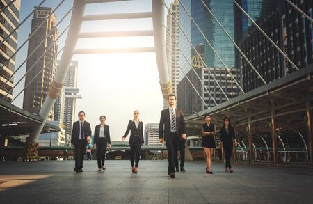 Group of professional business team walking outdoor with office building backgroundの写真素材