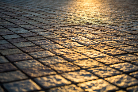 Texture of cobble stone path with sunset light, Blur focus background grunge styleの写真素材