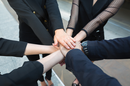 Business teamwork concept, Professional business man and woman team putting their hands together for Celebration unity, group of asia and caucasian nationalityの写真素材
