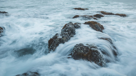 Dramatic seascape of rock on sea with wave background at Khao Na Yak at sunset in Phang Nga,...