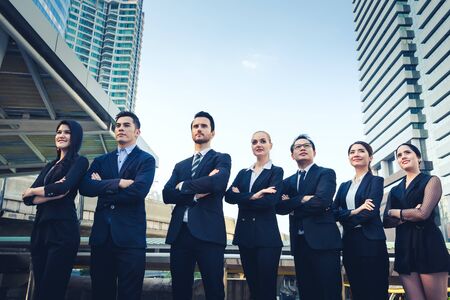 Group of professional business team cross one's arm outdoor with office building backgroundの写真素材