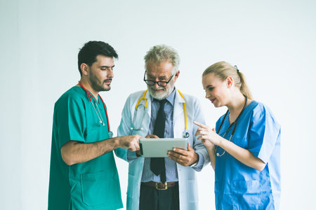 Group of happy doctor surgeon and nurse with tablet in meeting on white background, Healthcare and...