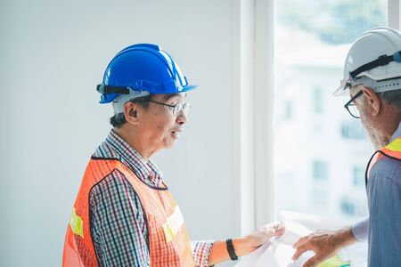 Engineer and contractor team discussing in meeting at construction site, Teamwork conceptの写真素材