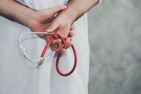 Back view of doctor with stethoscope in hand, medical conceptの写真素材
