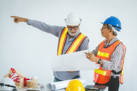 Engineer and contractor team discussing in meeting at construction site, Teamwork concept