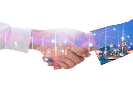 Professional teamwork and network connection technology concept, Double exposure of arab Business man handshake to his business partner with digital graphic against city night background in meetingの写真素材