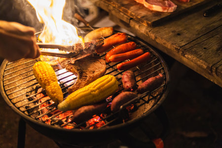 Family making barbecue in dinner party camping at nightの写真素材
