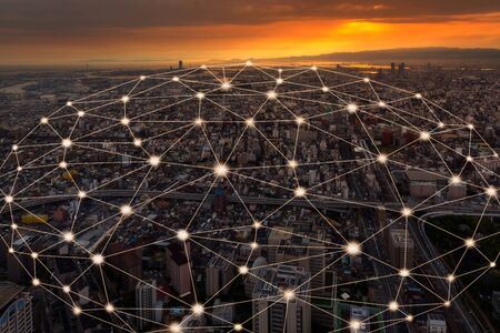 Wireless network and Connection technology concept with Osaka city background at sunset in Japan, panorama viewの写真素材