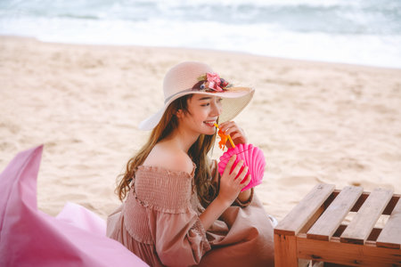 Travel summer vacation concept, Young asian woman with pink cocktail relax in cafe on Tutu beach, Pattaya, Thailandの写真素材