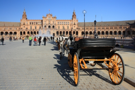 horse-driven carriage with tourists at Plaza de Espana in Sevilleのeditorial素材