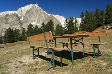wooden table and benches in Graian Alpsの写真素材