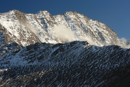early snow on mountain crest in Alpsの写真素材