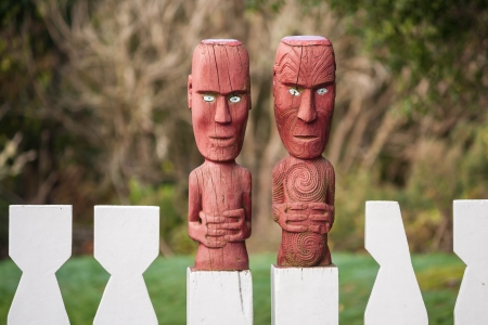 wooden fence with Maori carvingの写真素材