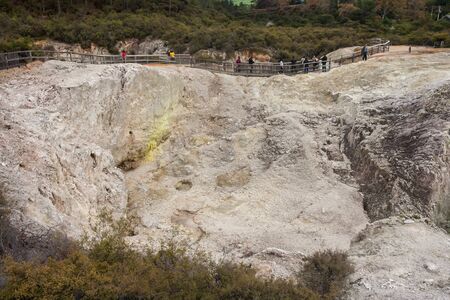 tourists on track above collapsed crater in Waiotapuの写真素材
