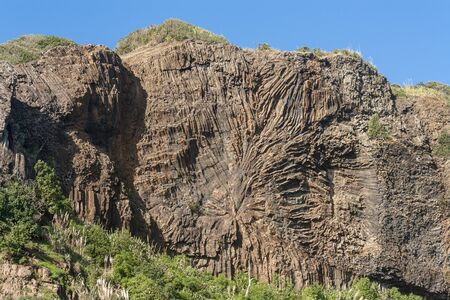 steep rock face at Muriwai beachの写真素材