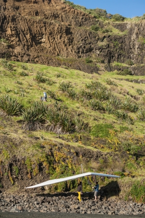 people carrying hand glider up steep slopeのeditorial素材