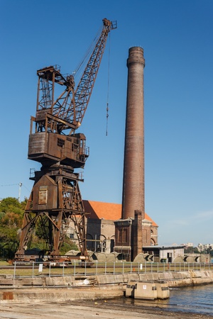 rusty crane with chimney on Cockatoo Islandの写真素材