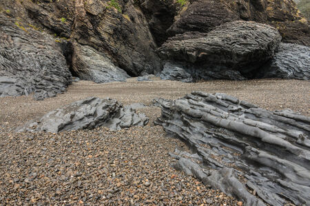 volcanic boulders on beach in Poley Bayの写真素材