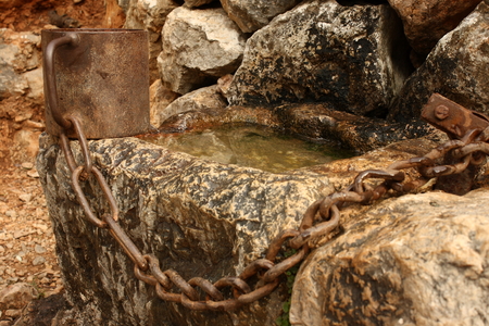 little well with chained iron cupの写真素材