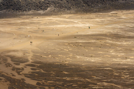 people walking accros barren land at Tongariro National Park の写真素材