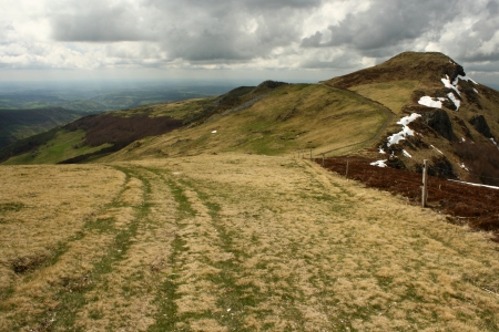 rolling hills with grass in Monts du Cantalの写真素材