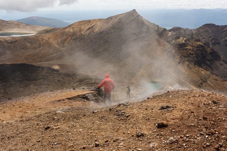 tourists descending on lava fieldの写真素材
