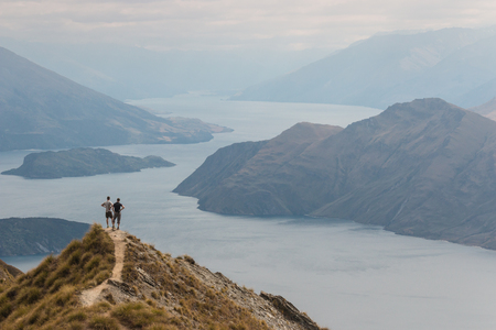 couple admiring lake Wanaka in New Zealandの写真素材