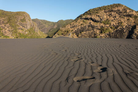 footprints accross black sand dune の写真素材