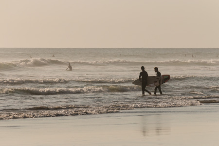 surfers at Piha beach, New Zealandのeditorial素材