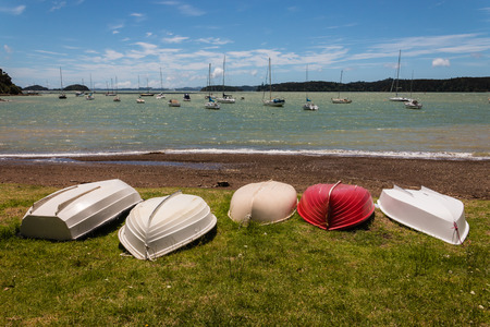 boats lying upside down on shore in Bay of Islandsの写真素材