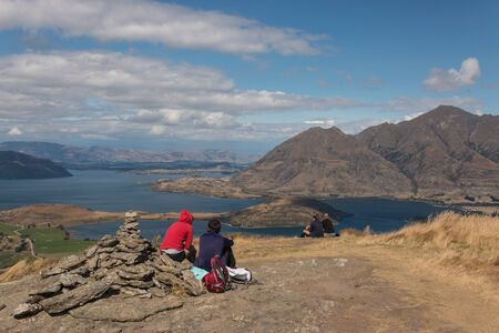 tourists resting above lake Wanaka, New Zealandのeditorial素材