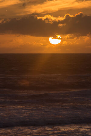 sunset over Muriwai beach, New Zealandの写真素材