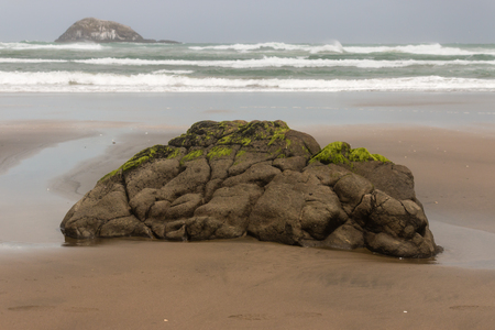 lava boulder on Muriwai beach, New Zealandの写真素材