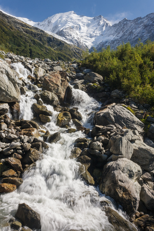stream from melting glacier in Graian Alpsの写真素材
