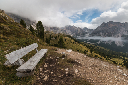 wooden bench in Puez-Geisler Nature Park, Dolomitesの写真素材